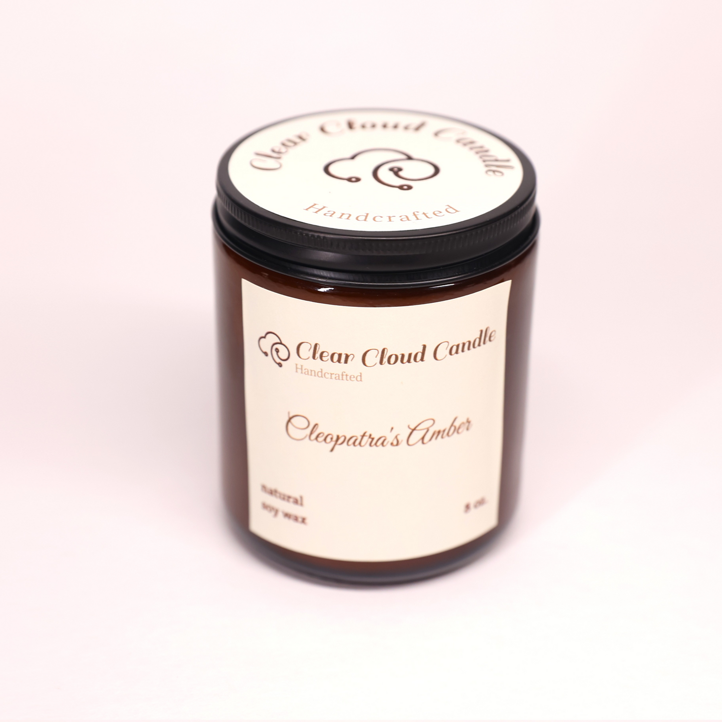 amber candle jar with light cream label. name: Cleopatra's amber