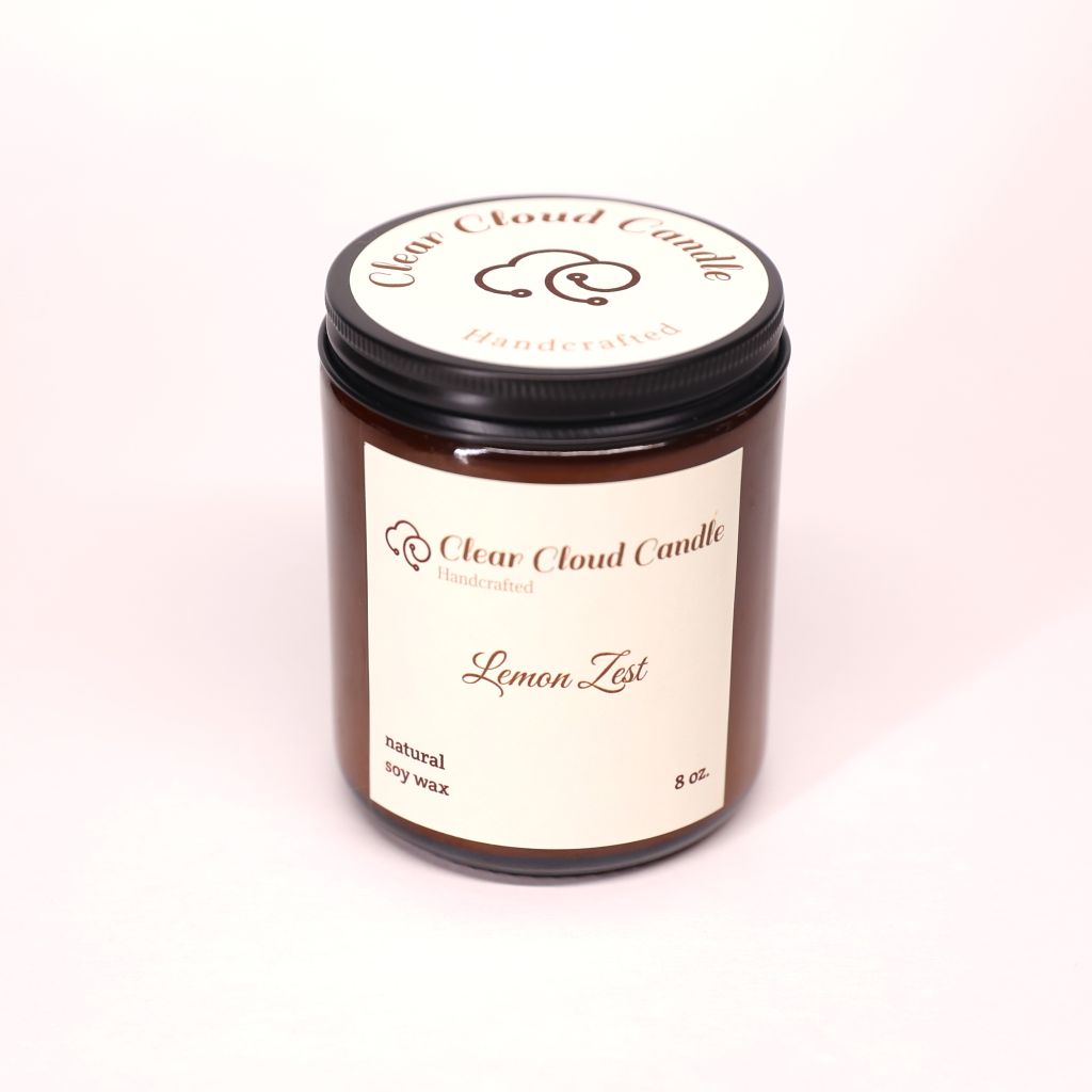 Clear Cloud Candle Amber jar with 'Lemon Zest' scented candle on a white background