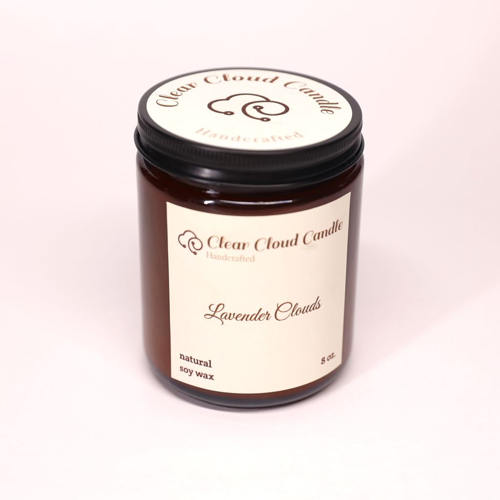 Clear Cloud Candle Co. in amber jar and cream label of lavender cloud scented candle on a white background