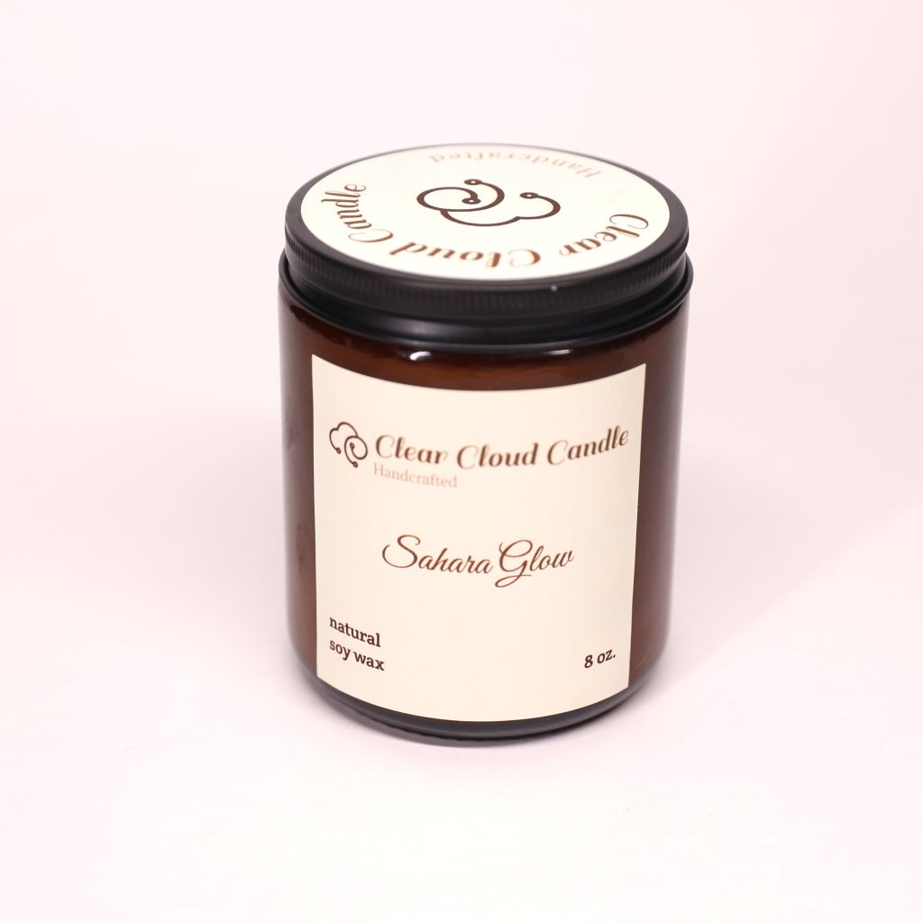 Amber Candle jar from 'Clear Cloud Candle' Co. with 'Sahara Glow' scent on a white background