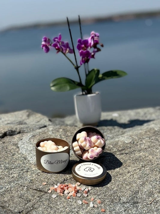 scented cloud-shaped was melts in tin container. orchid flower vase in the background