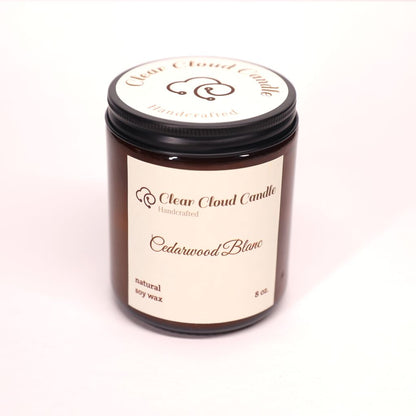 Amber color Candle jar with 'Clear Cloud Candle' Co. label. Scent name is "Cedarwood Blanc", on a white background.