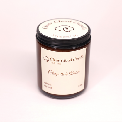 amber candle jar with light cream label. name: Cleopatra's amber
