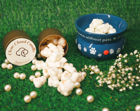 Cloud-shaped wax melts in tin container, next to wax Melter with pet paws